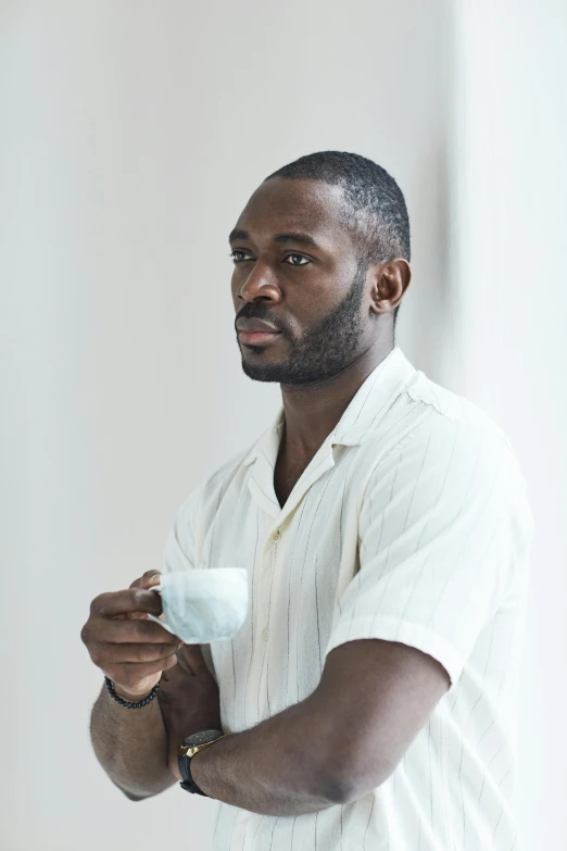 a man with an electronic device standing in a room