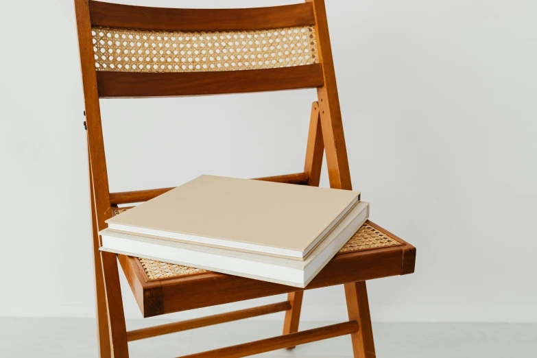 two books on the back of an unfinished chair