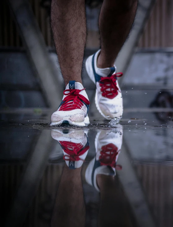 the back of a person wearing blue and red shoes