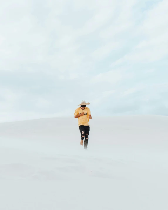 a man walking through a snow covered field