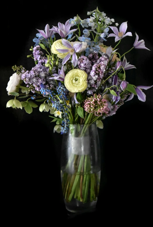 an assortment of flowers in a glass vase