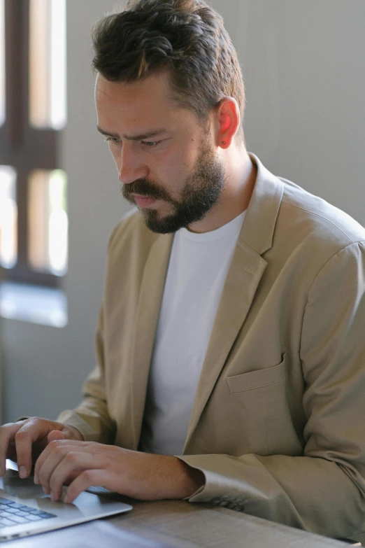 a man sitting in front of a laptop computer