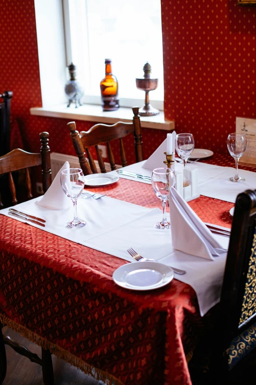 the dining room has two tables with place settings