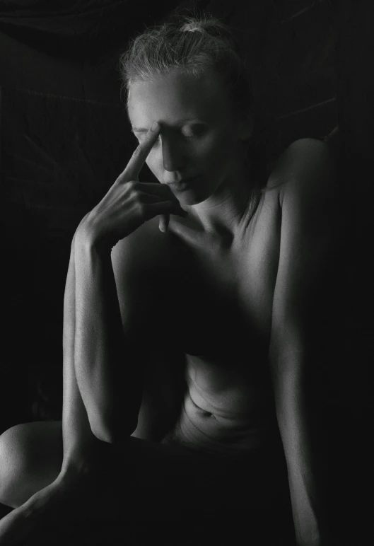  woman in dark room looking at the camera