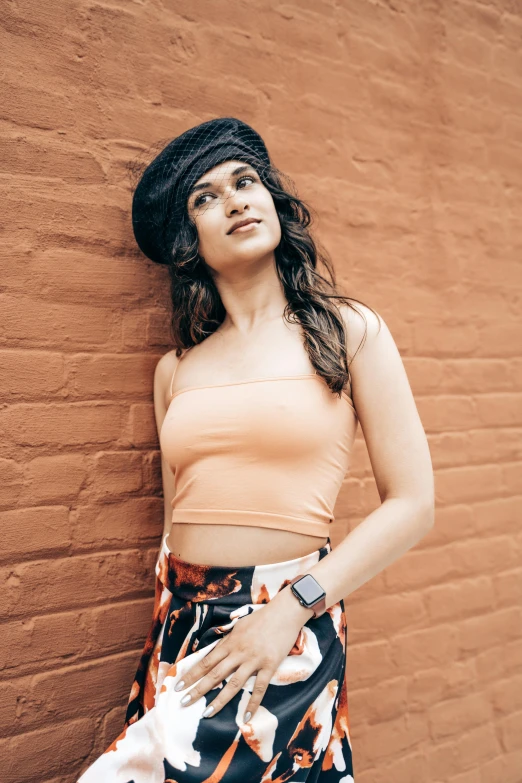 a woman in a flowery print skirt and crop top