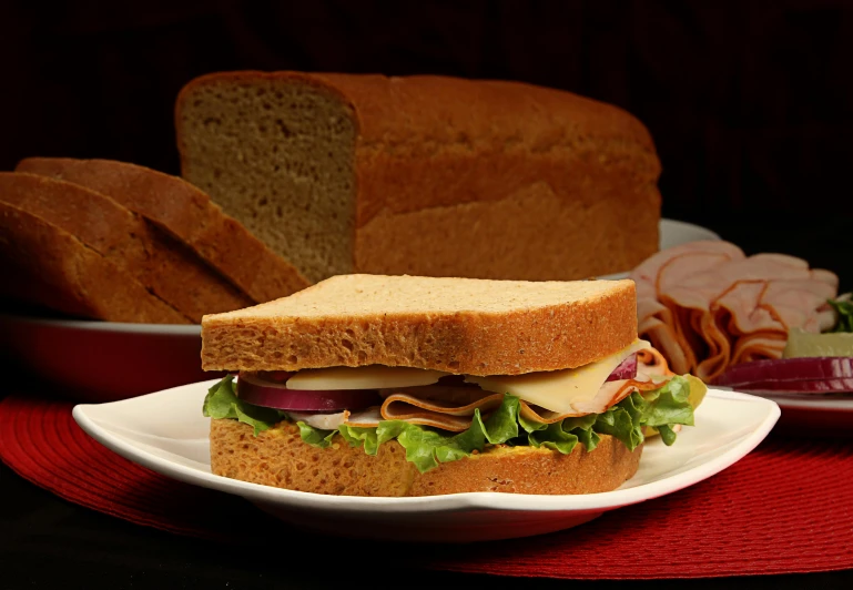 a very big sandwiches on a plate with some sort of bread