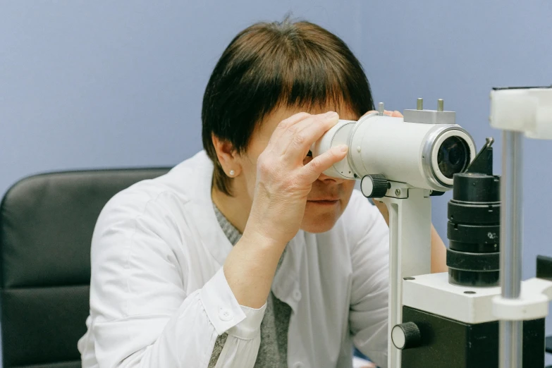 a person holding up a pair of glasses to view soing