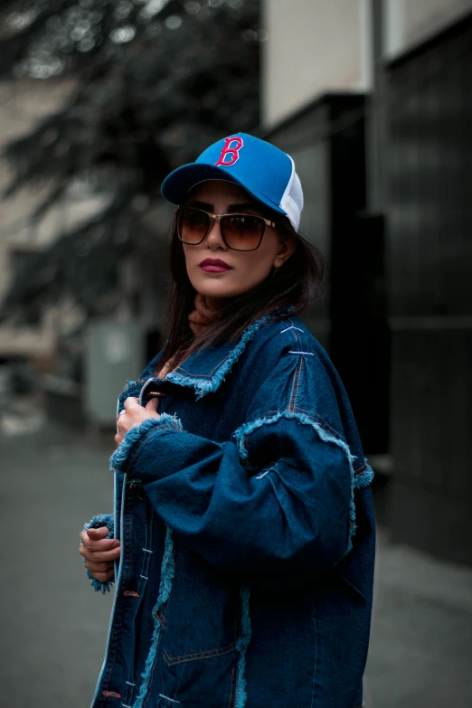 the girl is posing with her baseball cap