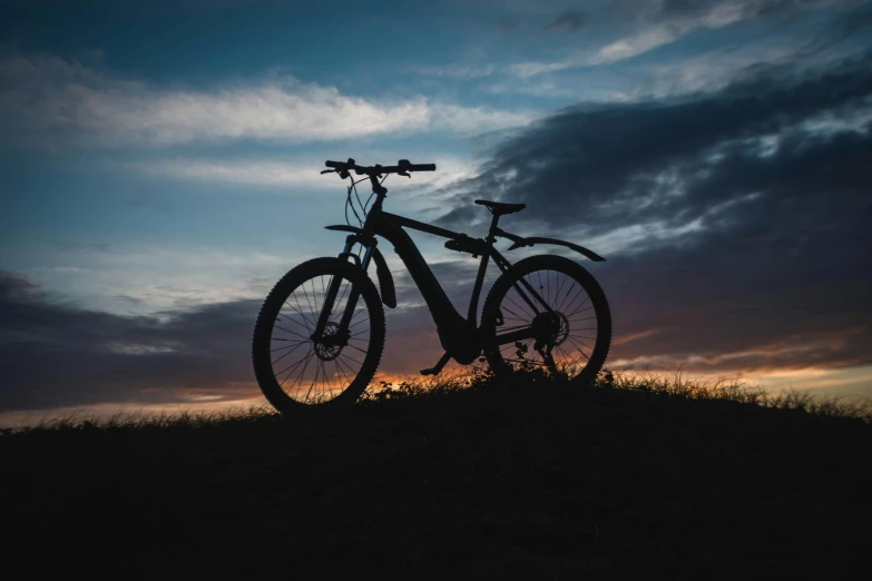 silhouette of a bike with the sun setting