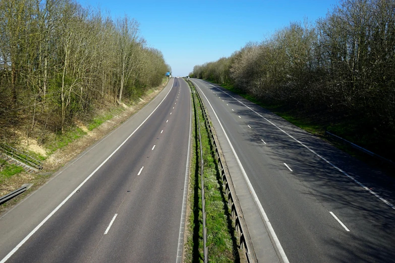 an empty road with two lanes and three lanes
