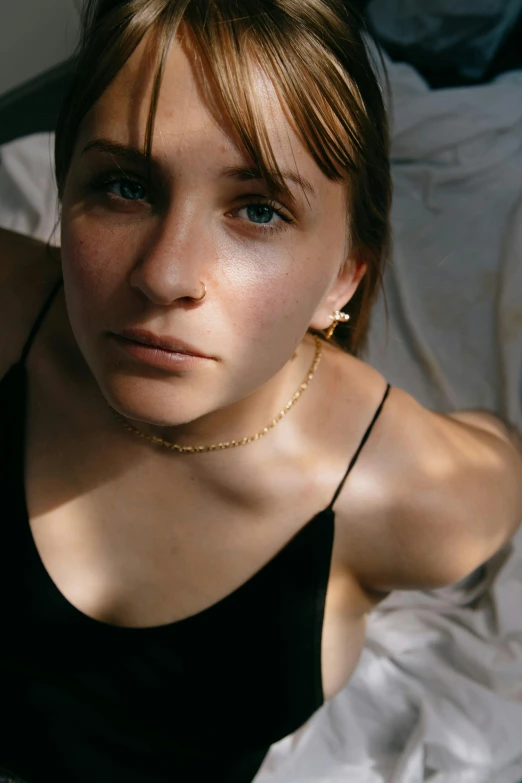 a woman with large earrings looks intently into the camera