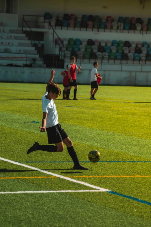 people standing around a soccer ball on the ground