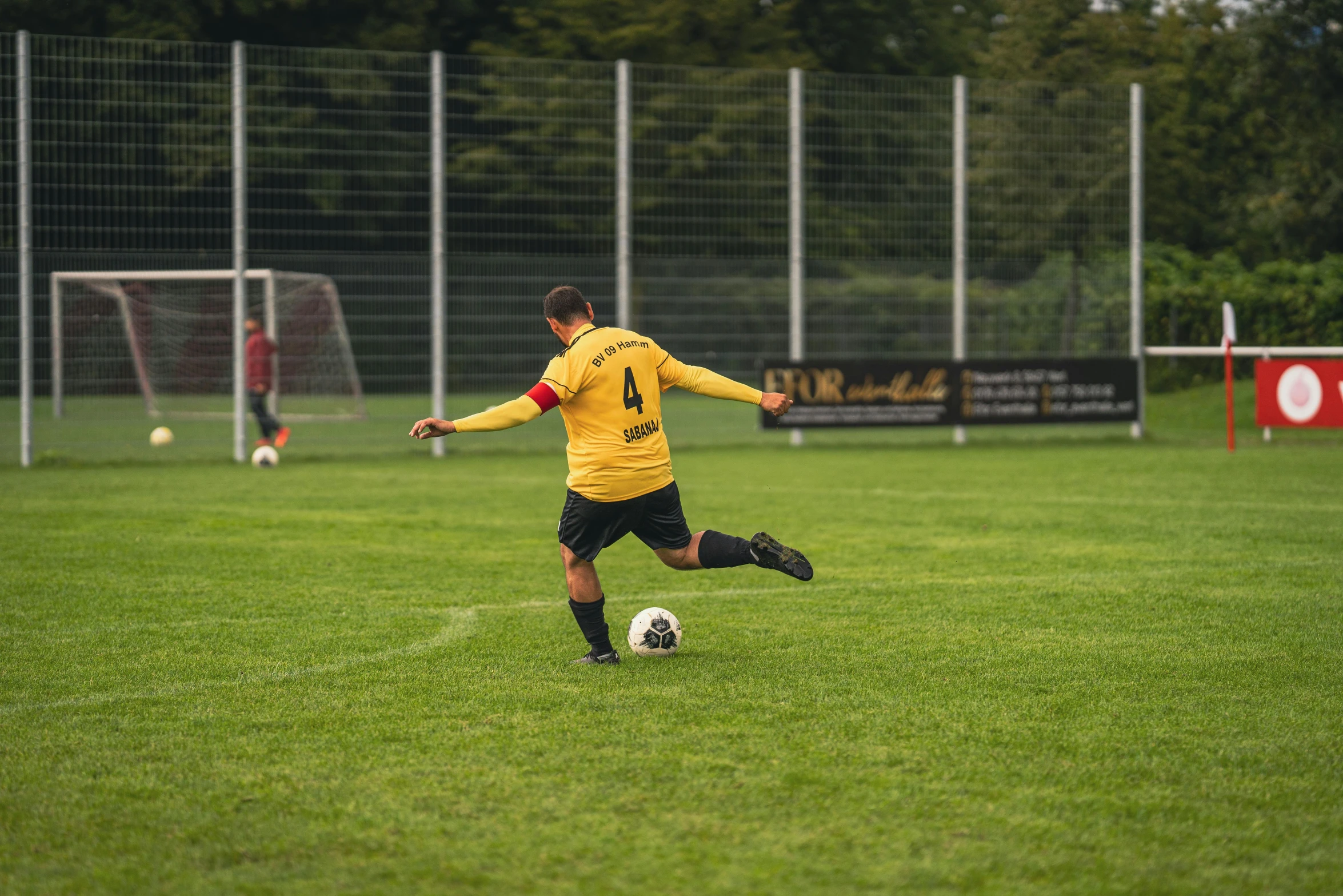 a soccer player is playing ball on a field