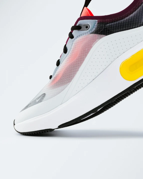 the nike air max is made with a mesh mesh upper, black and white upper, a red bottom and a yellow bottom