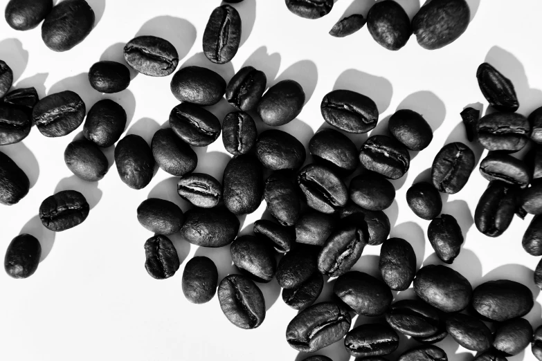 coffee beans are shown on a white surface