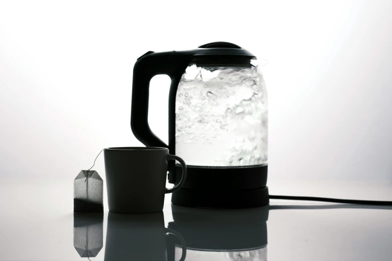 a tea kettle and coffee mug on a table