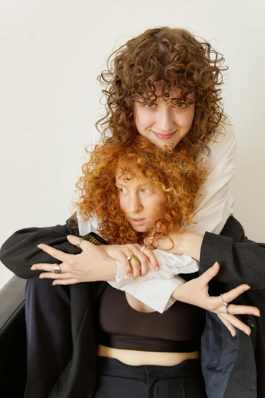 two woman in crop top tops are posing for a po