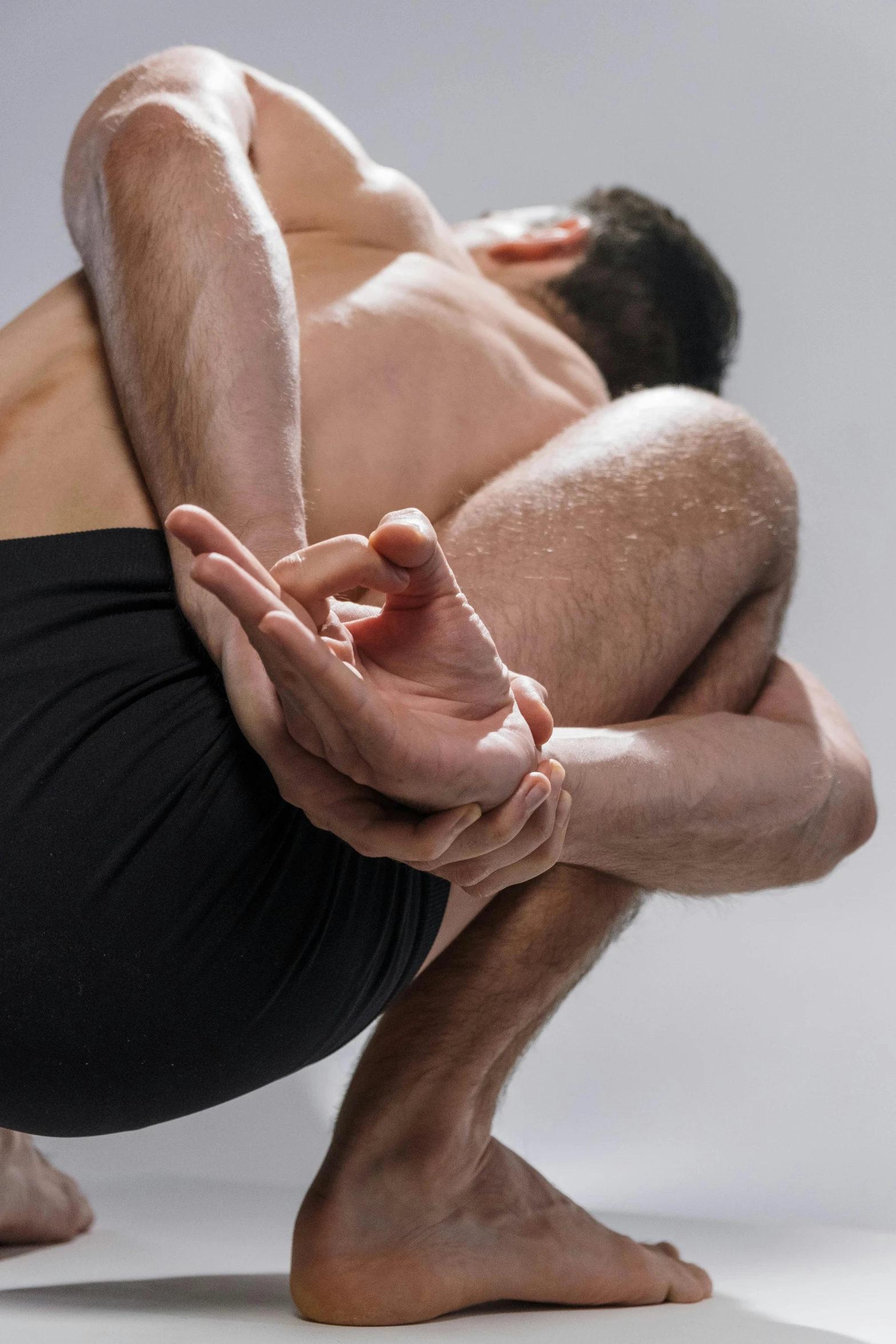 a man bending forward in yoga pose