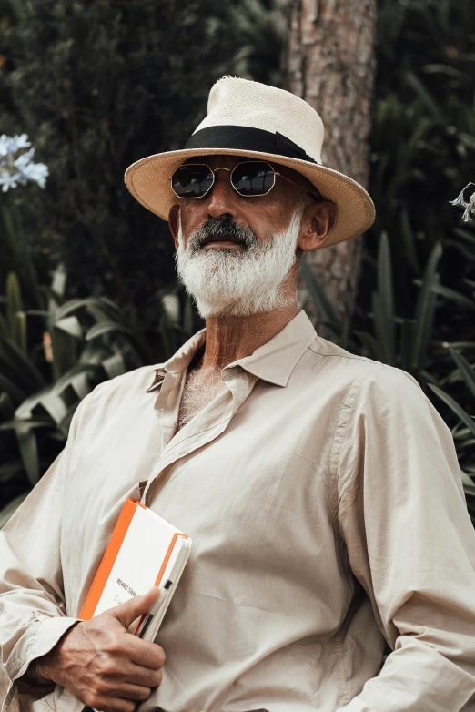 a man with grey hair wearing a hat and sunglasses