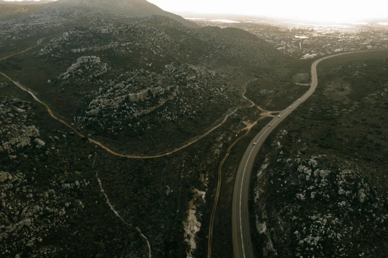 there are three roads through the trees and hill