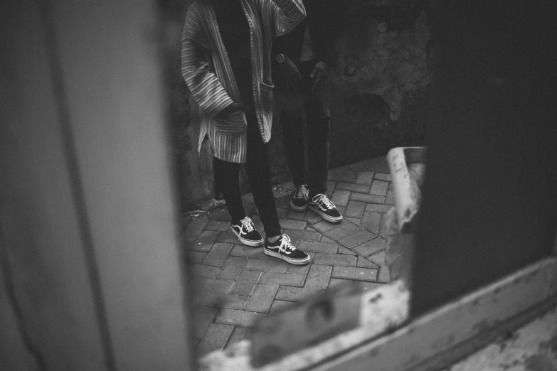 the reflection of two people standing outside of a building