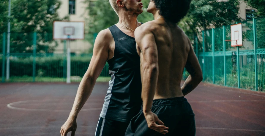 two young men who are on a basketball court
