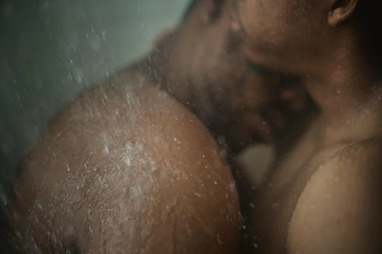 the reflection of two men kissing in a mirror