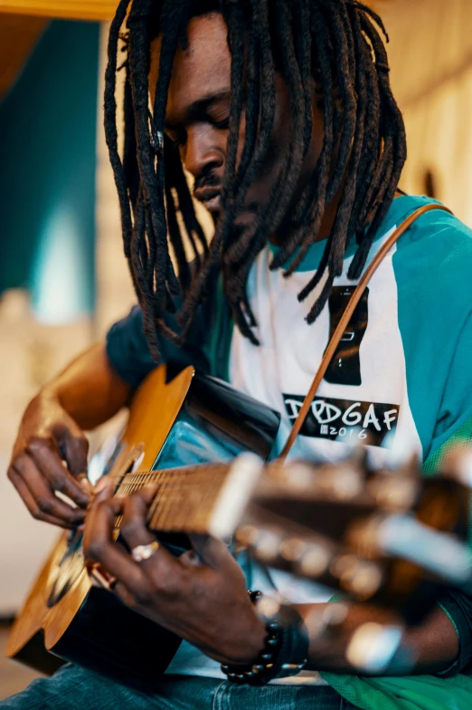 a man is playing the guitar by himself