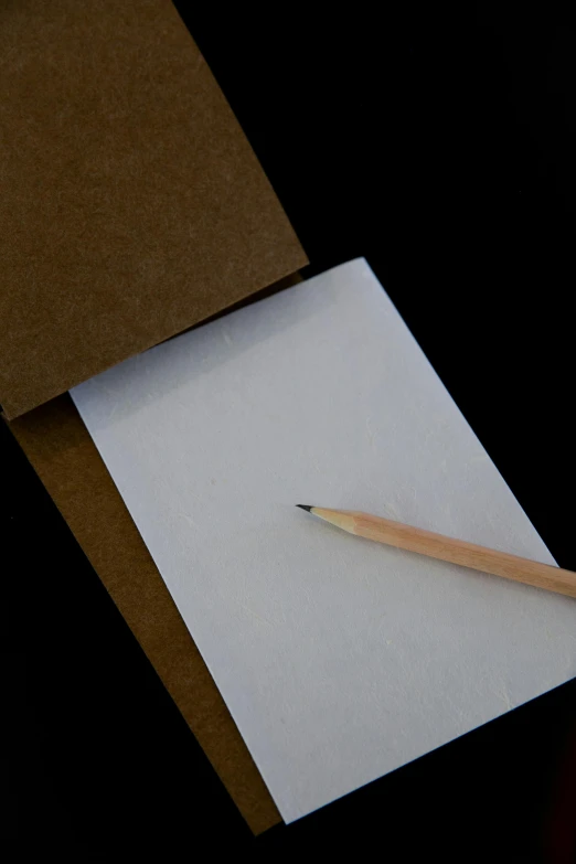 a pencil resting on top of a piece of paper