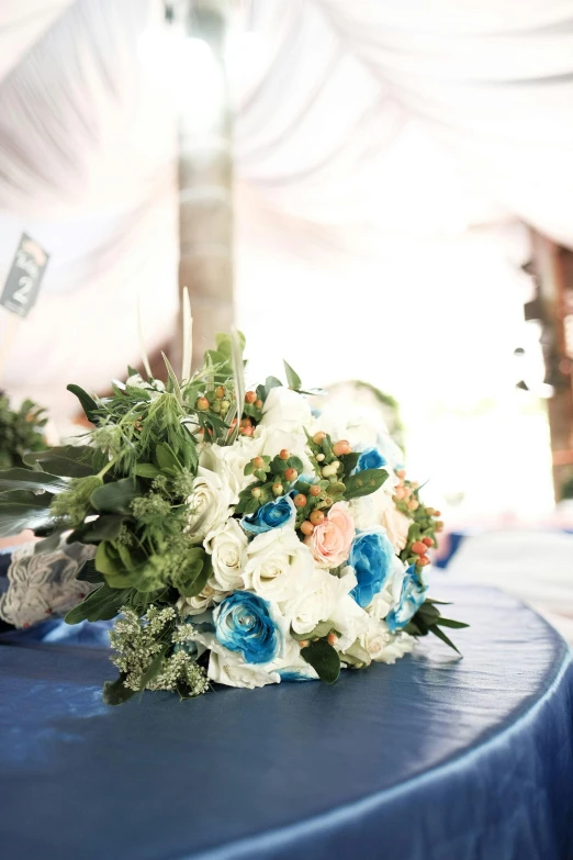wedding bouquet on table with canopy in background