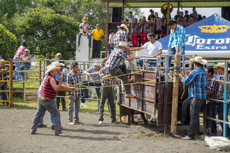 a man is trying to rope a group of people in a corral