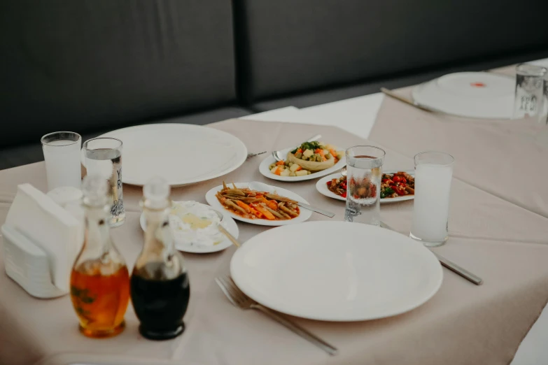 table with two plates and wine glasses on it