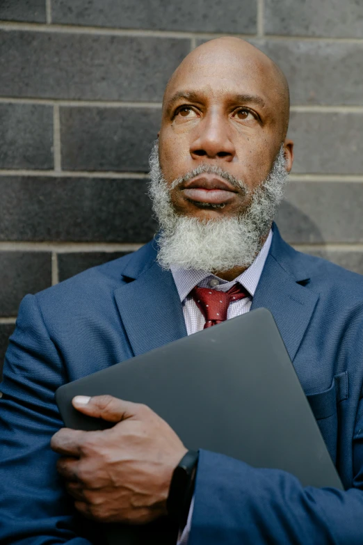 a man wearing a suit and tie with a folder