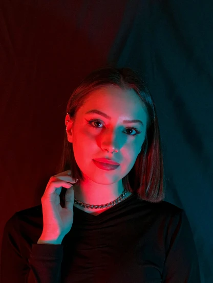 a woman poses for a picture in the dark