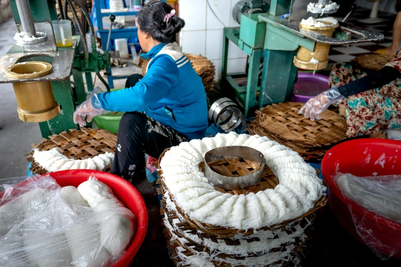 woman preparing various items for crafts in factory