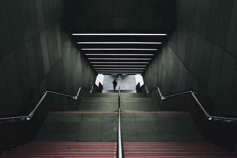 an escalator view into a building next to a man