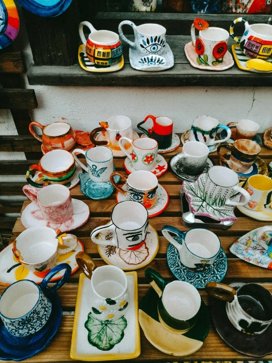 a bunch of coffee mugs sitting on top of a table