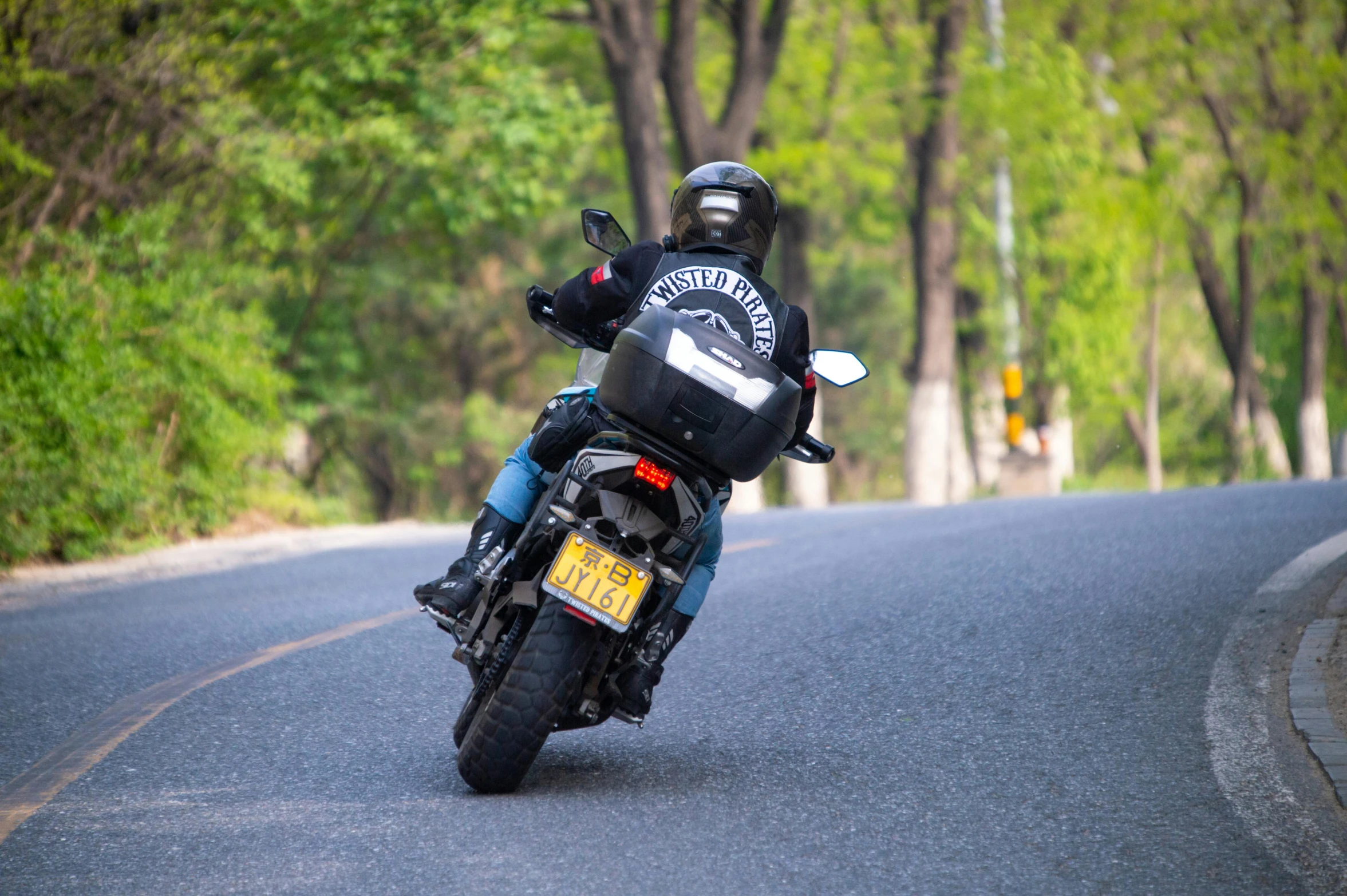a person riding on the back of a blue motorcycle