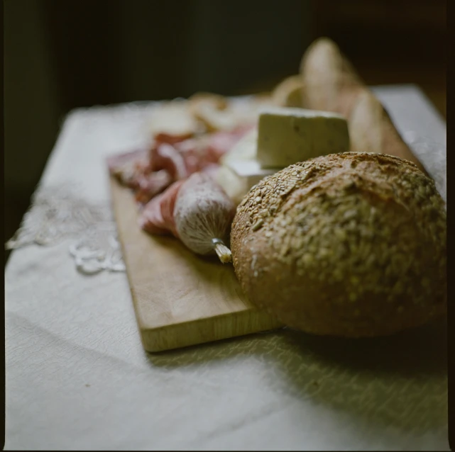 a counter topped with bread and meats on it