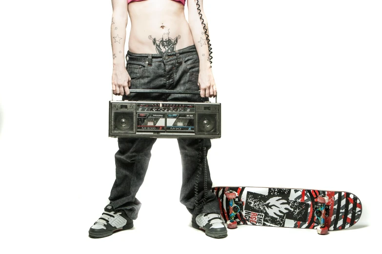 woman in a shirt holding a boom box and skateboard