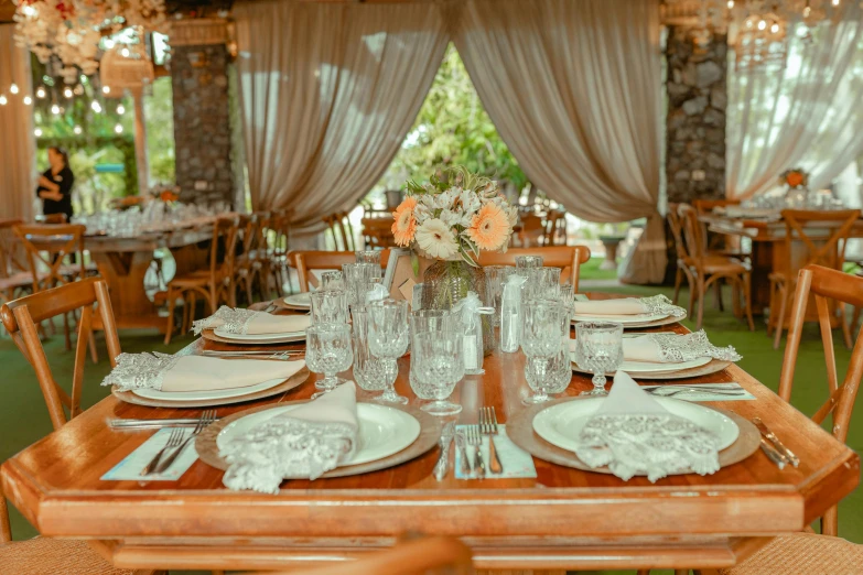 a long table set for an elegant dining occasion with flowers in vases