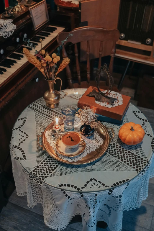 a plate is set on top of a table by an old piano
