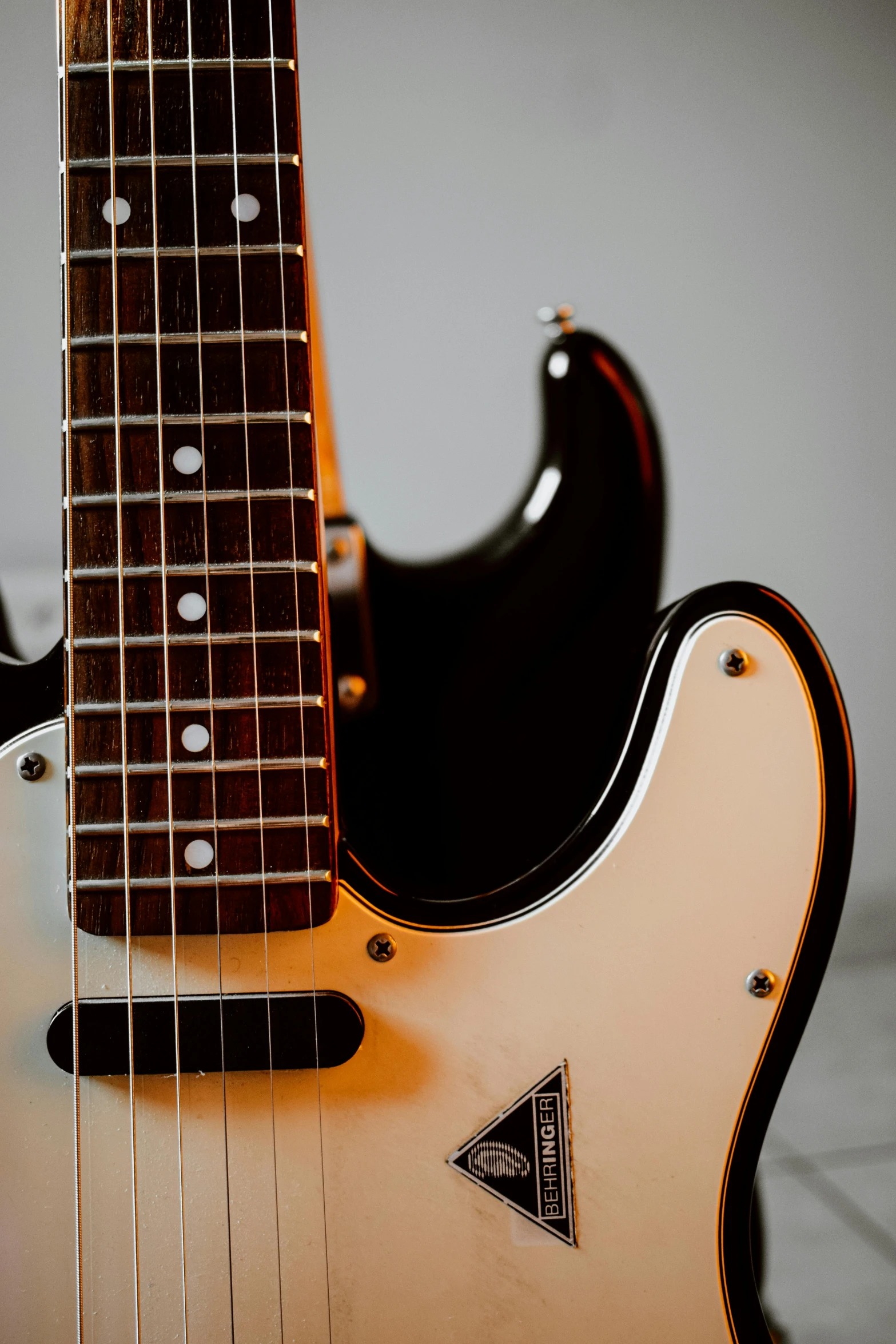 a yellow and black guitar head and neck