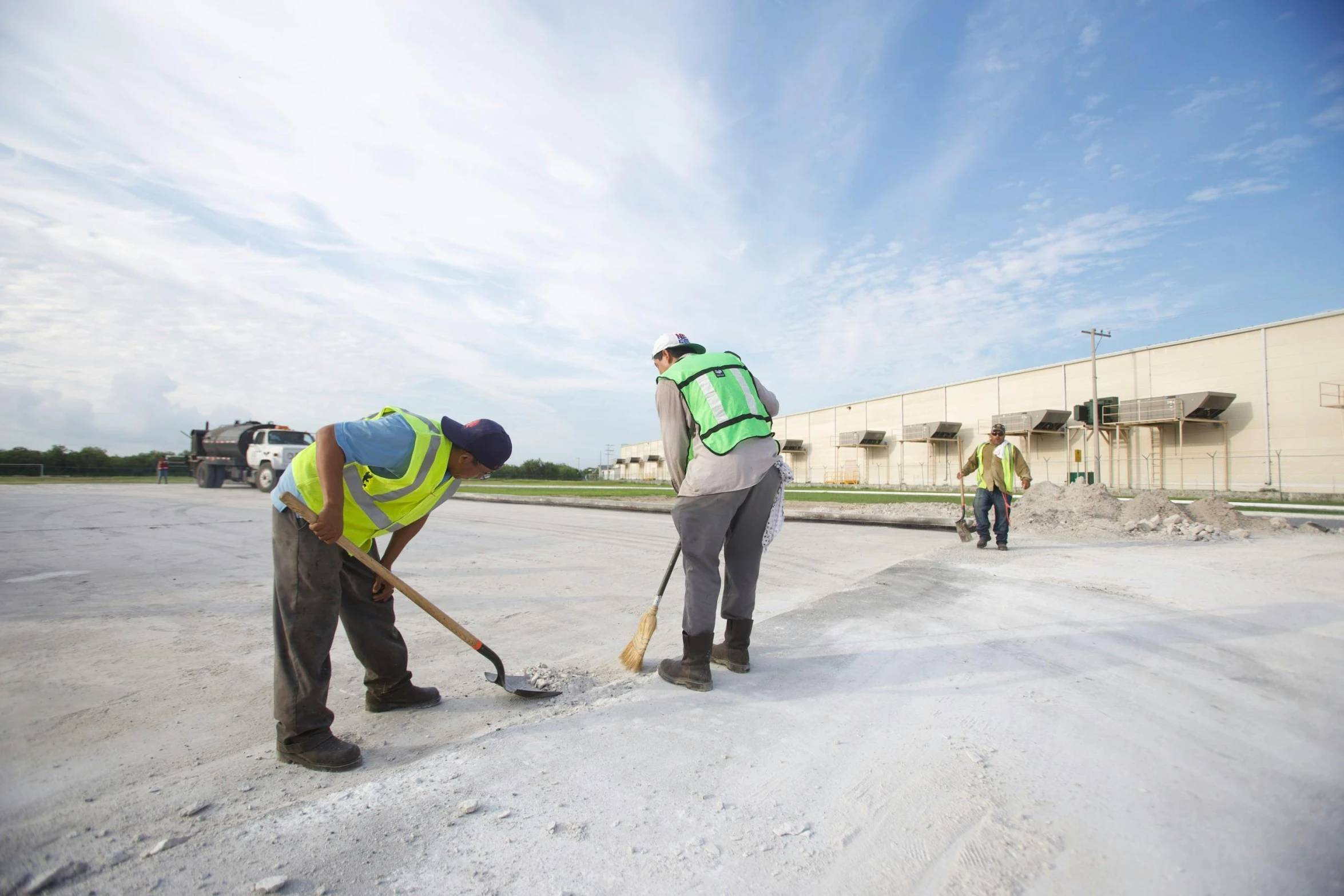 the men are working on the street with the same equipment