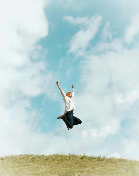 a man flying a kite on a hill