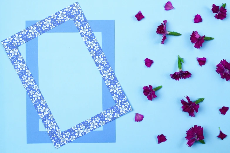 a blue paper piece is sitting next to some flowers