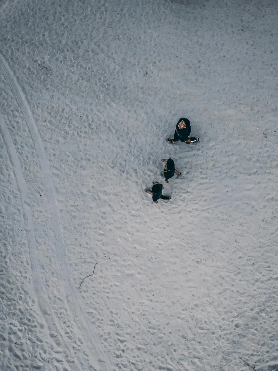 a couple of people with a snowboard are laying in the snow