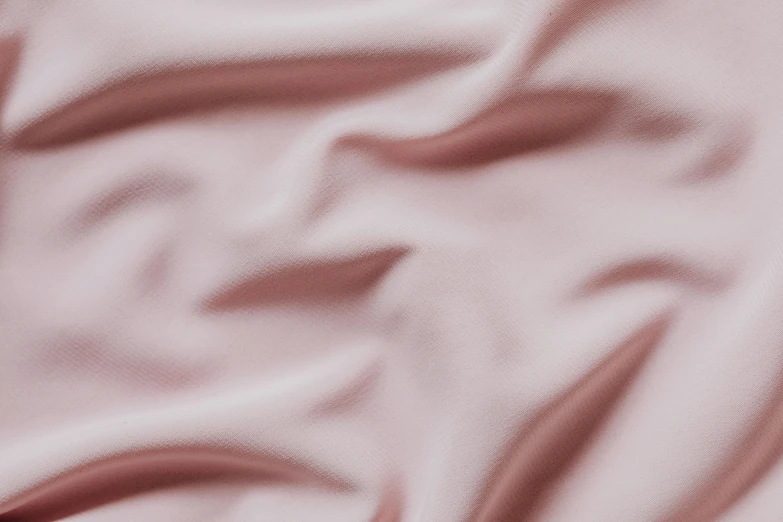 a light pink background of silky, soft material