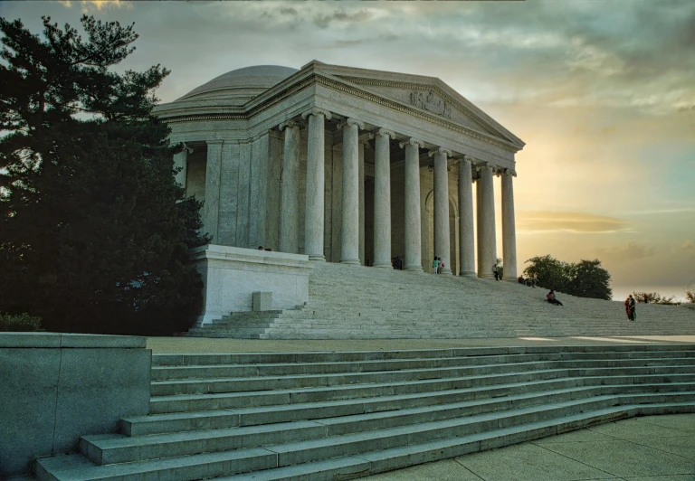 a man standing next to steps leading up to a monument