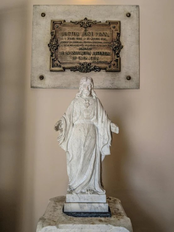 a white statue is on display in a room